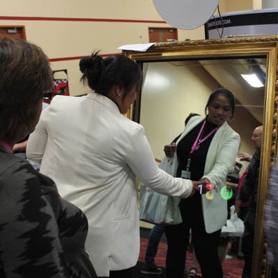A lady using the Selfie Mirror Booth at a corporate event in Nottinghamshire
