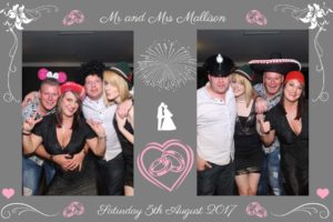 guests at a wedding in Nottingham enjoying the Magic Mirror Booth wearing funny hats